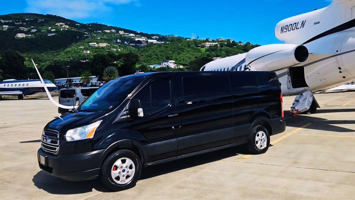 Black van on an airport tarmac with a private jet in the background